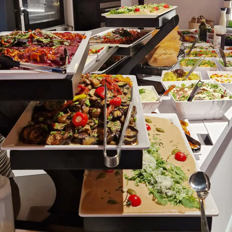 Ein Buffet mit kalten und warmen Speisen, stilvoll angerichtet und unter anderem mit einer Etagere versehen.